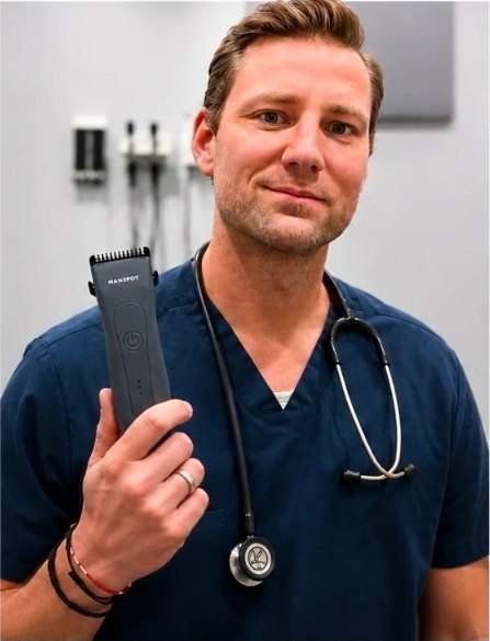Jonathan Pittard PA-C holding a MANSPOT body trimmer in a clinical setting
