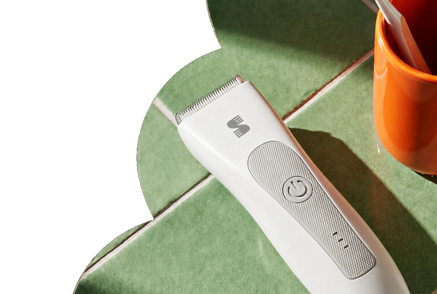 White SPOTMATE body trimmer on green bathroom tile with transparent shaped cutout edge