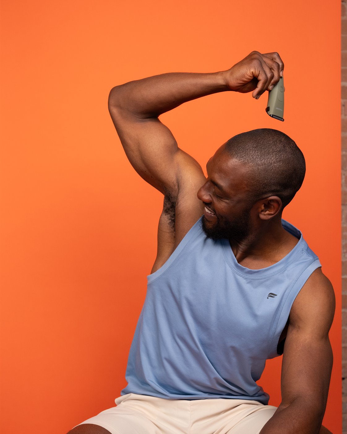 Man using a MANSPOT trimmer for comfortable underarm grooming